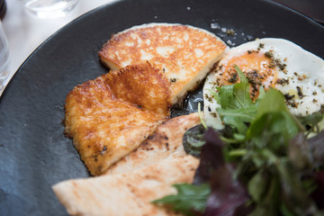 Image of very delicious and tasty eggs and cheese breakfast seen being served at Ottolenghi restaurant. The food seems to be very delicious and looks very fresh.