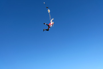 Obraz na płótnie Canvas Skydiver is in the blue sky.