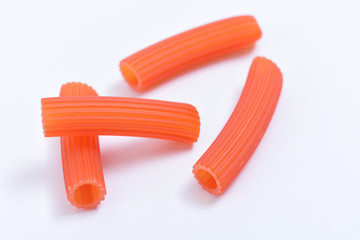 Pasta red macaroni on white