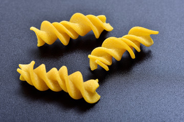 Pasta fusilli on black background