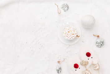 Flat lay marshmallows in the white cup and Christmas composition on the white cozy background. Holiday concept,