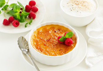 Creme brulee. dessert with caramel crust and berries.