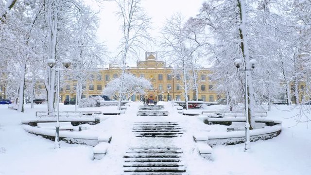 Aerial footage of Kiev Polytechnic University in winter. Snowy stairs to the main campus