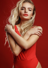 Naklejka premium Fashion portrait of a young woman in red dress