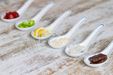 POrcelain spoons with food ingredients