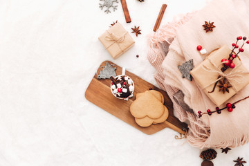 Hot cocoa with marshmallow and decorations. Hot cocoa and keyboard and warm knitted sweater. Flat lay blogger composition, cozy home
