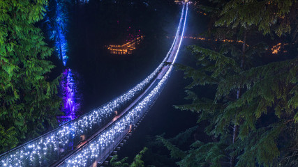 Long exposure at night, foggy view with Christmas lights of the Capilano Suspension Bridge. Vancouver. Beautiful British Columbia, Canada.