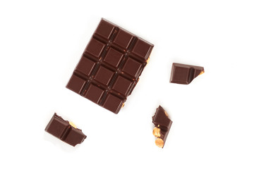 bar of dark chocolate with hazelnuts. Pieces of chocolate with nuts, isolated on white background.