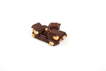 Chocolate pieces with nuts isolated on white background