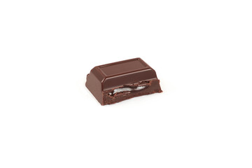Close-up pieces of chocolate bar with filling isolated on white background.