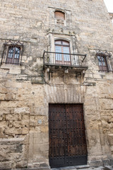 Fototapeta premium Exterior of a local building in Spain. The building seems to be a mix of old and modern architecture. The Streets seem to be narrow. It seems to be a sunny day.