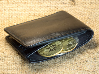 Bitcoin in a purse on rough burlap