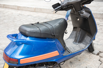 A police vehicle is seen parked at the side of the road. The color of the vehicle is blue. The road in seen on the background.