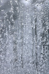 Naklejka na ściany i meble Frozen drops and snow on frosted glass