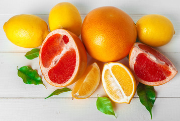 Grapefruit with slices on a wooden table.