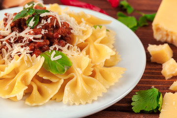 Pasta with meat, tomato sauce and vegetables on the table