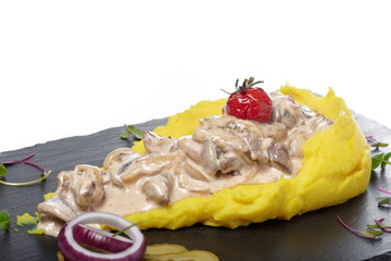 Mashed potatoes with meat sauce isolated on white background