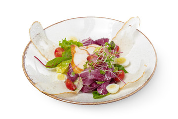 salad with chicken on a white plate on a light background