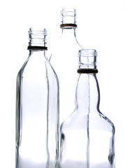 Empty glass wine bottles on a white background