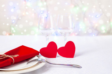 Valentines and two wine glasses on a white background. Valentine's Day celebration