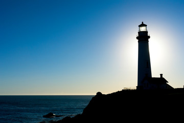 Naklejka premium Lighthouse Silhouette at Sunset