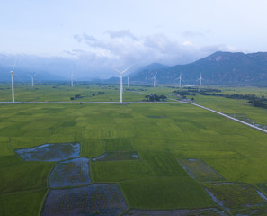 Wind turbine farm or windmill on blue sky. Turbine green energy electricity or wind turbine in a green field - Energy Production with clean and Renewable Energy. Phan Rang, Vietnam