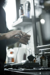 The male hands and tools for cutting beard at barbershop. Vintage tools of barber shop