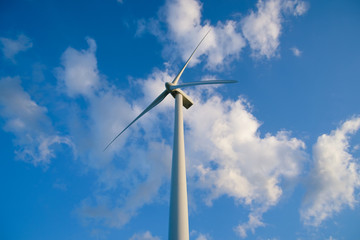 Wind turbine farm or windmill on blue sky. Turbine green energy electricity or wind turbine in a green field - Energy Production with clean and Renewable Energy. Phan Rang, Vietnam