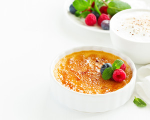 Creme brulee. dessert with caramel crust and berries.