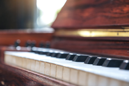 Closeup image of a vintage wooden grand piano