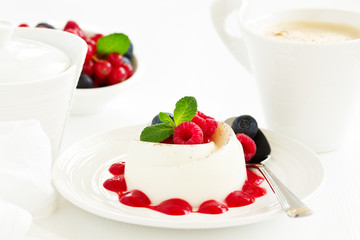 Delicious Italian dessert panna cotta with berries and berry sauce. Valentine's Day.