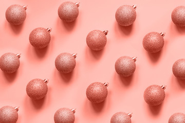 Christmas baubles decoration on living coral background. Minimal flat lay composition.