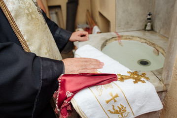 The priest performs the rite at the time of the baptism of the newborn