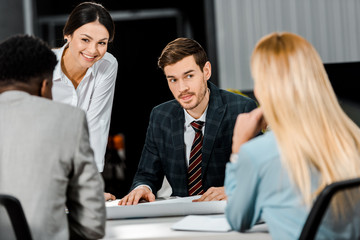 young multiethnic businesspeople having discussion during meeting in office