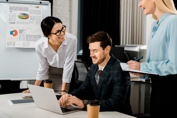 smiling business colleagues having meeting in office
