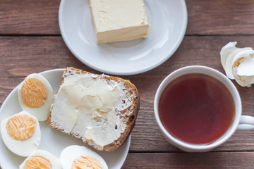 rustic Breakfast in the morning, bread and butter, boiled eggs and tea
