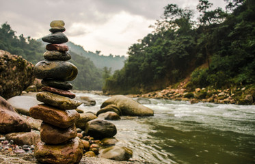 Zen stones balancing near the river banks in the Himalayas.