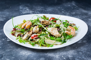 Seafood Salad Salad with prawns, mussels, squids, onions and spring onions decorated by tomatoes cherry rocket salad
