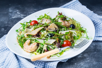 Seafood Salad Salad with prawns, mussels, squids, onions and spring onions decorated by tomatoes cherry rocket salad