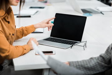 cropped shot of businesswomen working on project together at workplace in office