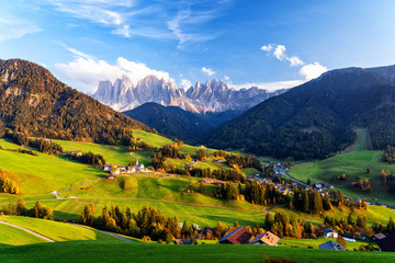 Obraz premium Santa Maddalena village with magical Dolomites mountains in background, Val di Funes valley, Trentino Alto Adige region, Italy, Europe. Sunset view of dramatic Italian Dolomites landscape.