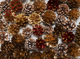 Christmas background with pine cones on white wooden background