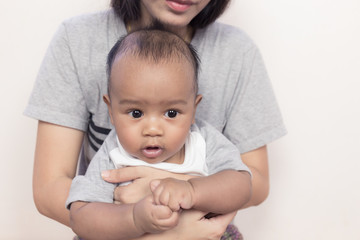 Fototapeta na wymiar mother holding a newborn asian baby