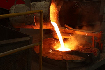 Molten iron pour from ladle into melting furnace ; industry foundry metallurgy engineering...