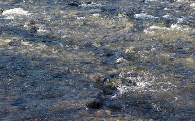 Obraz premium A close view of the flowing water surface of the creek.