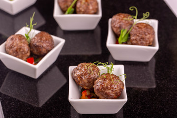 Giving portion meat quenelles with vegetables