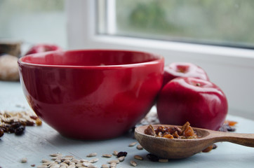 Close up image of bowl of healthy gluten free oatmeal with nuts and raisins