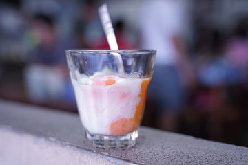 Soft boiled eggs in the transparent glass with metal spoon