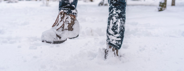 man legs foot in warm winter boots walking in the snow f