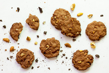 Baked Christmas cookies. Homemade Chocolate Chip Cookies with Nuts on a light stone table. Top view flat lay background.